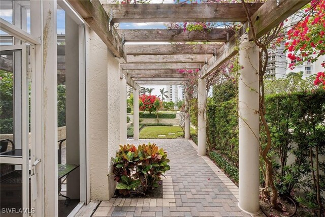 4021 Gulf Shore Blvd N Unit V-16, Naples, FL 34103 - view of patio / terrace featuring a pergola