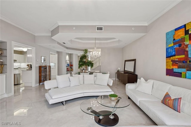 living room with an inviting chandelier, a tray ceiling, and crown molding