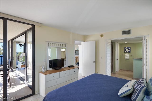 bedroom featuring access to exterior and light tile patterned floors