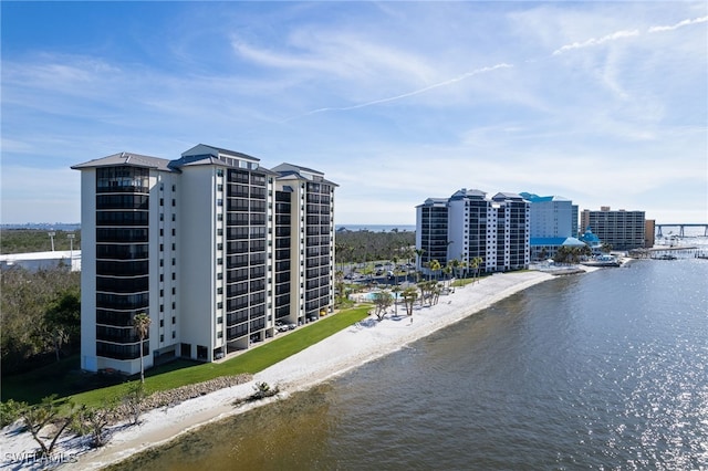 drone / aerial view with a water view and a beach view