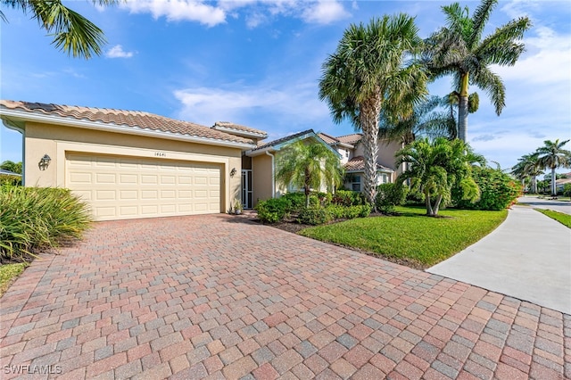 view of front of property with a garage and a front lawn