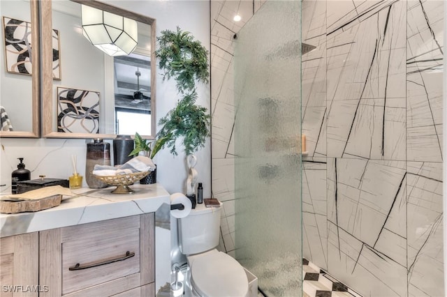 bathroom featuring an enclosed shower, vanity, and toilet