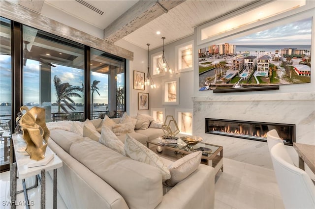 home theater room featuring a high end fireplace and beam ceiling