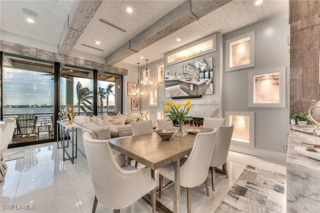 dining space with beam ceiling and a premium fireplace