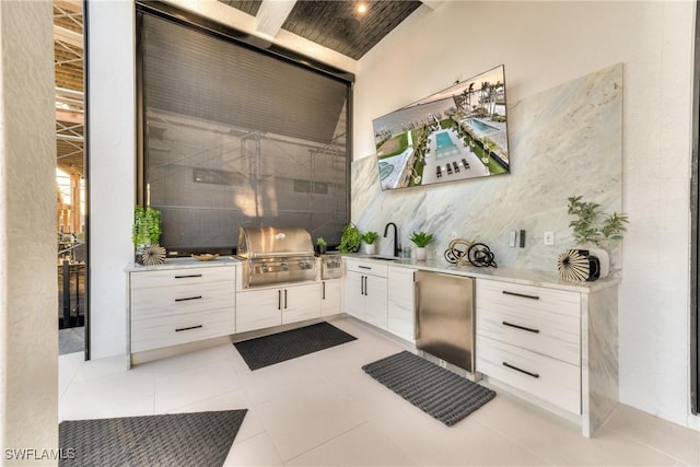 view of patio / terrace featuring a grill, an outdoor kitchen, and sink