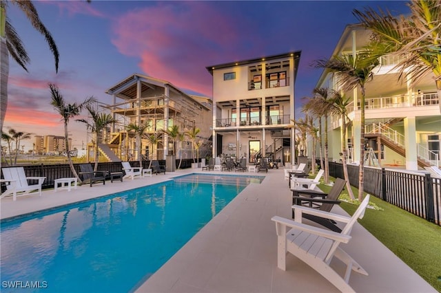 pool at dusk with a patio