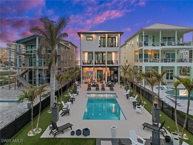 back of house with a community pool, a patio area, and fence
