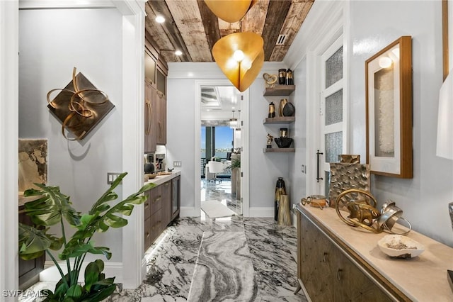 hall featuring marble finish floor and baseboards