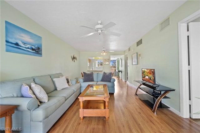 living room with light wood-type flooring and ceiling fan