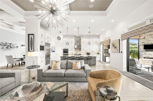 living room with crown molding and a chandelier