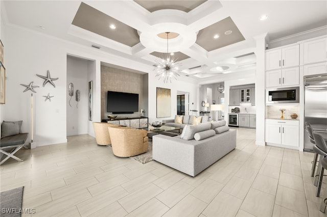 living room with an inviting chandelier, coffered ceiling, wine cooler, ornamental molding, and beam ceiling