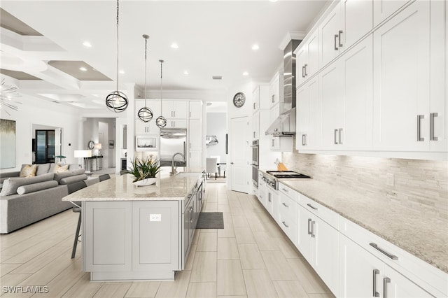 kitchen featuring decorative backsplash, coffered ceiling, a spacious island, pendant lighting, and white cabinetry