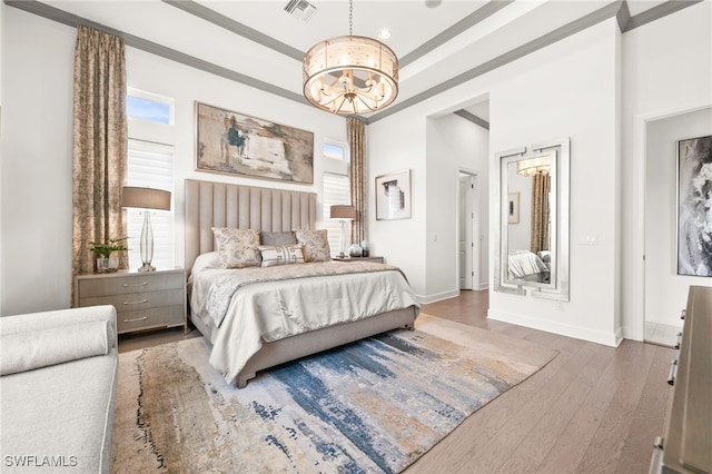 bedroom with dark wood-type flooring and an inviting chandelier