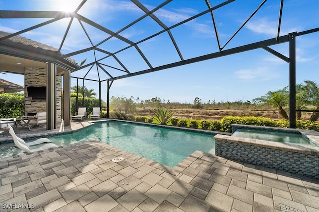 view of swimming pool with an in ground hot tub, a patio, and a lanai