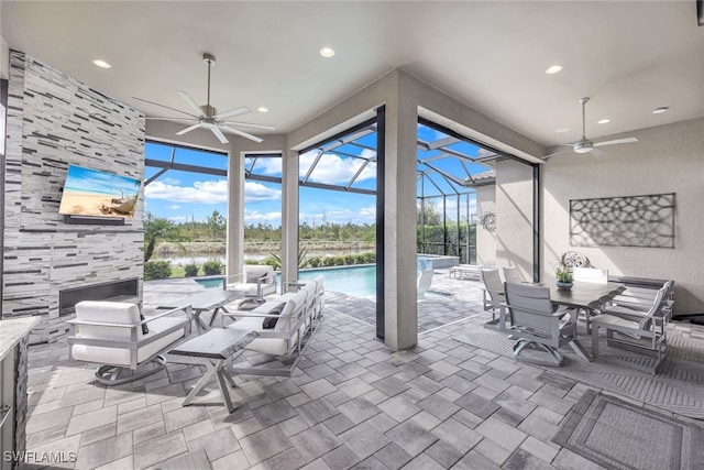 view of patio with glass enclosure and ceiling fan