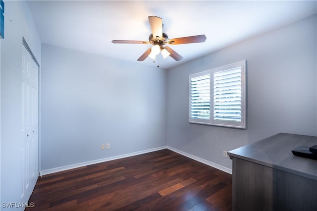 unfurnished bedroom with ceiling fan and dark wood-type flooring