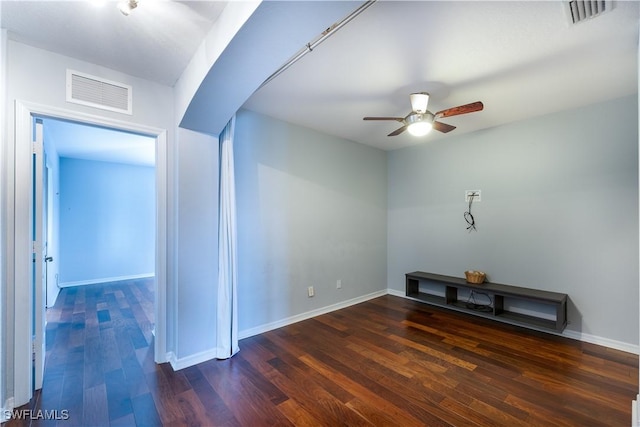 unfurnished room featuring ceiling fan and dark wood-type flooring