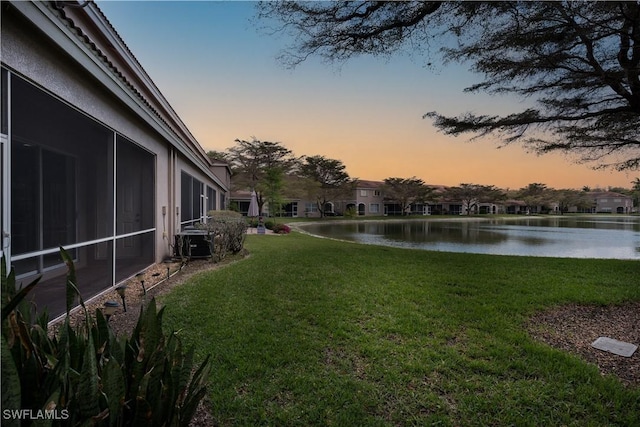 yard at dusk with a water view