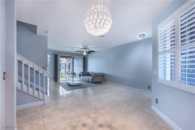 unfurnished living room with light tile patterned floors and ceiling fan with notable chandelier