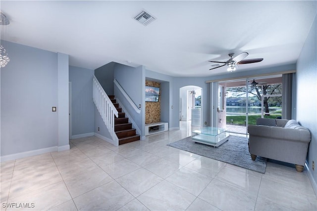 unfurnished living room with ceiling fan and light tile patterned floors