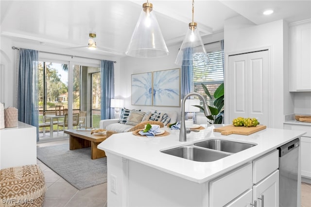 kitchen with a kitchen island with sink, sink, white cabinetry, decorative light fixtures, and stainless steel dishwasher