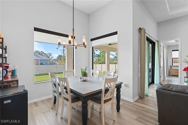 dining room with a chandelier and light wood-type flooring