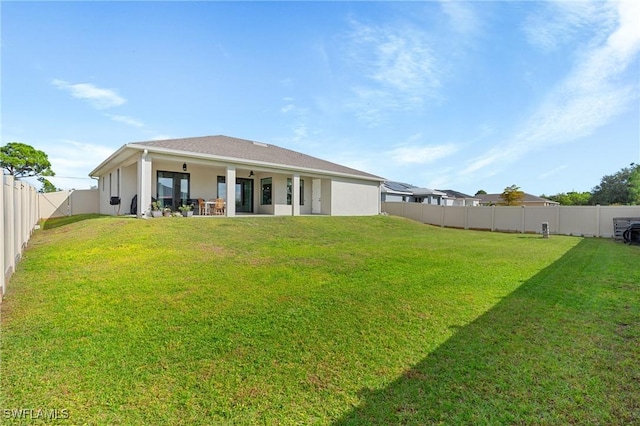 back of house with a lawn