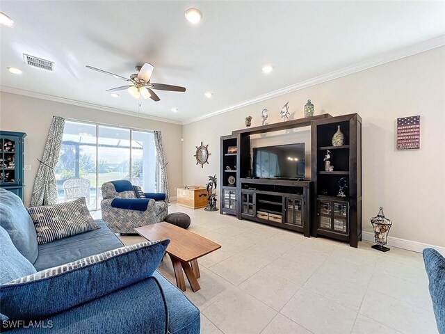 tiled living room with ceiling fan and crown molding