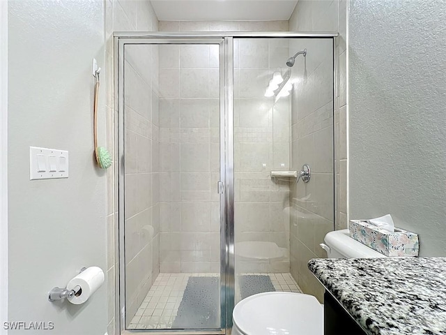 bathroom featuring toilet and walk in shower