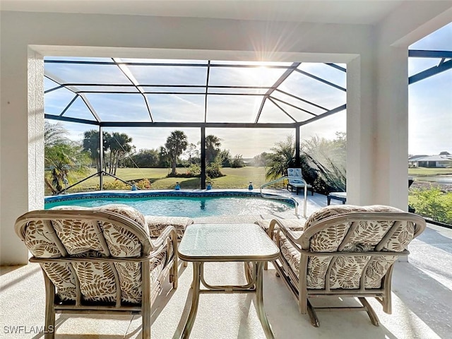 pool featuring glass enclosure and a patio area