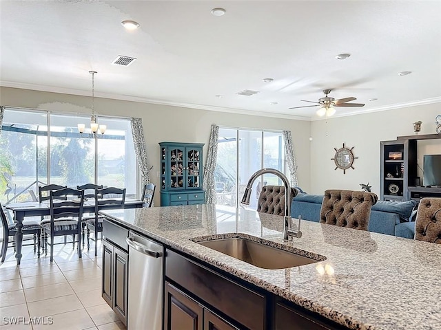 kitchen featuring dishwasher, sink, light tile patterned floors, ornamental molding, and light stone counters