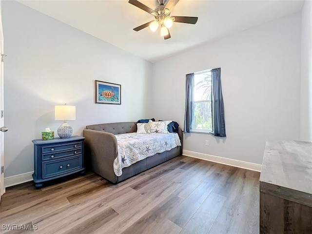 bedroom with ceiling fan and light hardwood / wood-style floors