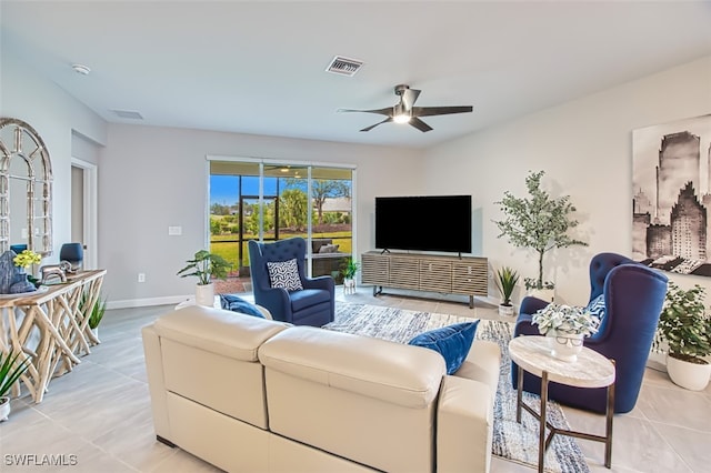 living room with baseboards, a ceiling fan, visible vents, and light tile patterned flooring