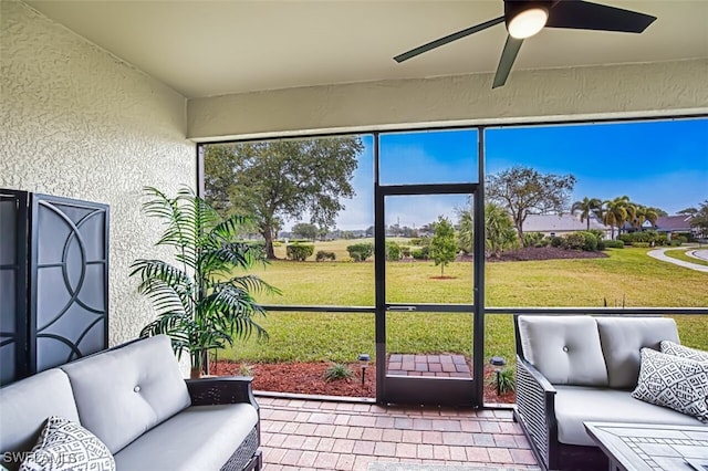 sunroom with an outdoor living space and a ceiling fan