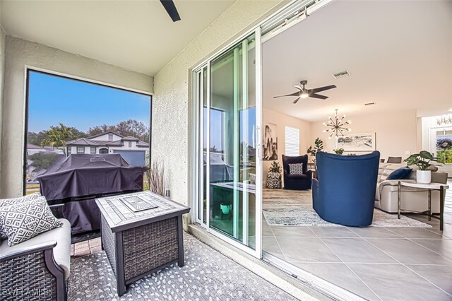 balcony with ceiling fan, a grill, an outdoor fire pit, and a patio area