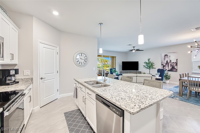 kitchen with hanging light fixtures, a sink, ceiling fan, stainless steel appliances, and white cabinetry