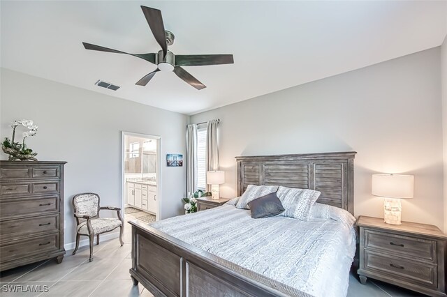 bedroom featuring light tile patterned floors, ceiling fan, and ensuite bathroom