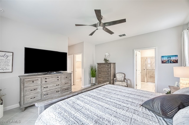 tiled bedroom with ensuite bathroom and ceiling fan