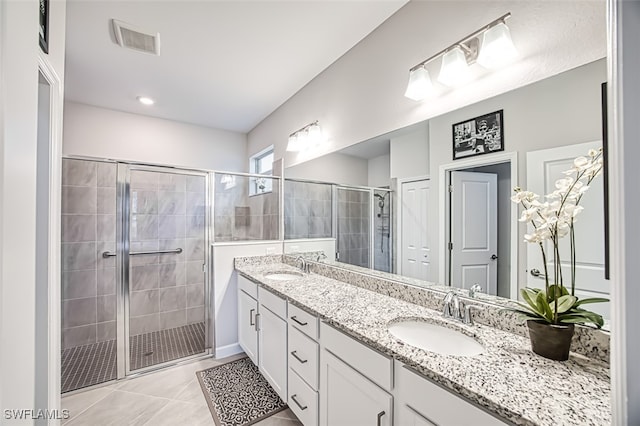 bathroom featuring tile patterned flooring, vanity, and walk in shower