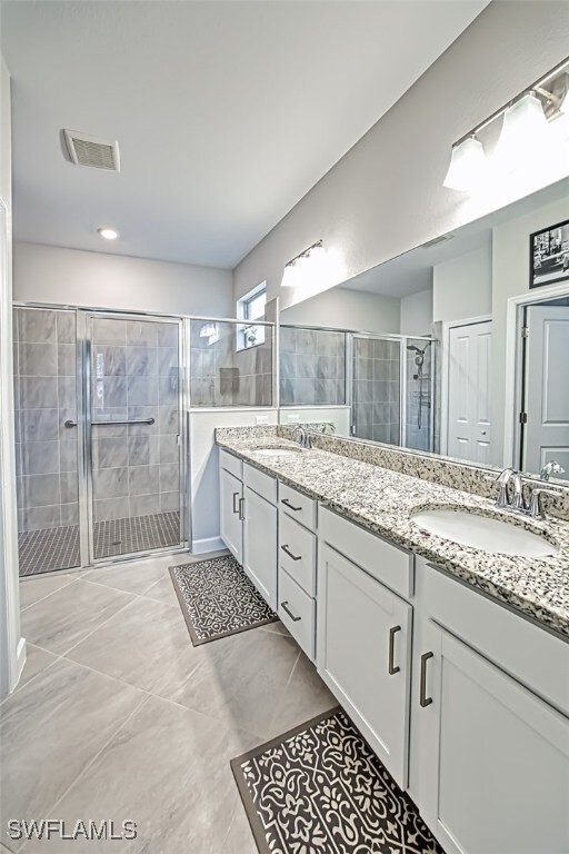 bathroom with walk in shower and vanity