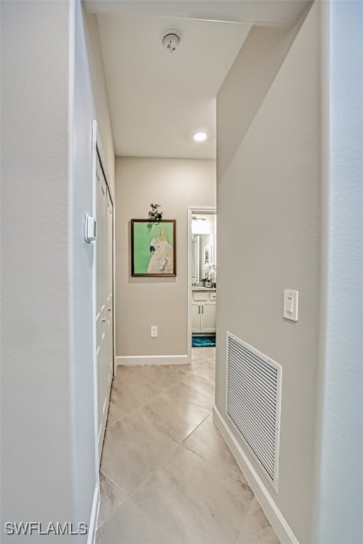 hall with light tile patterned floors