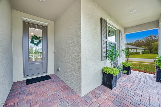 3101 E Windsor Dr, Alva, FL 33920 - doorway to property with stucco siding and covered porch