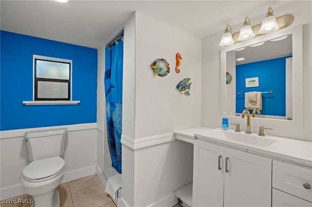 bathroom featuring tile patterned flooring, vanity, walk in shower, and toilet