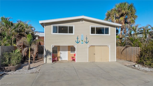 201 Miramar St, Fort Myers Beach, FL 33931 - view of front facade with fence, driveway, and an attached garage