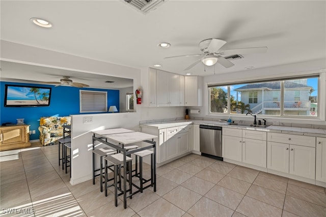 kitchen with sink, stainless steel dishwasher, white cabinets, and ceiling fan