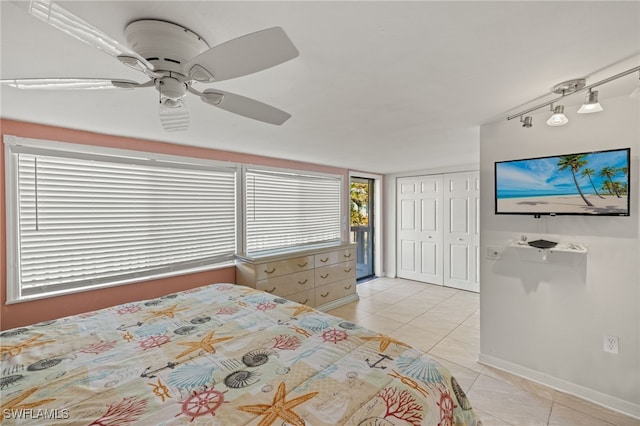 bedroom with ceiling fan, a closet, and light tile patterned floors