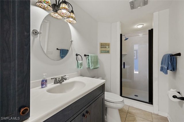 bathroom featuring walk in shower, vanity, toilet, and tile patterned flooring