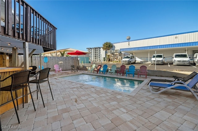 201 Miramar St, Fort Myers Beach, FL 33931 - view of pool featuring outdoor dry bar, a patio, a fenced in pool, and fence