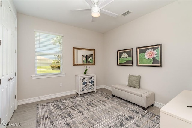 sitting room with light hardwood / wood-style flooring and ceiling fan