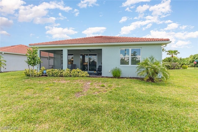 back of house with a yard and ceiling fan